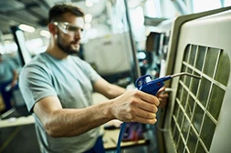 a man holding a AC welding torch