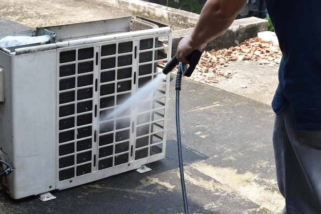 a person spraying a air conditioner